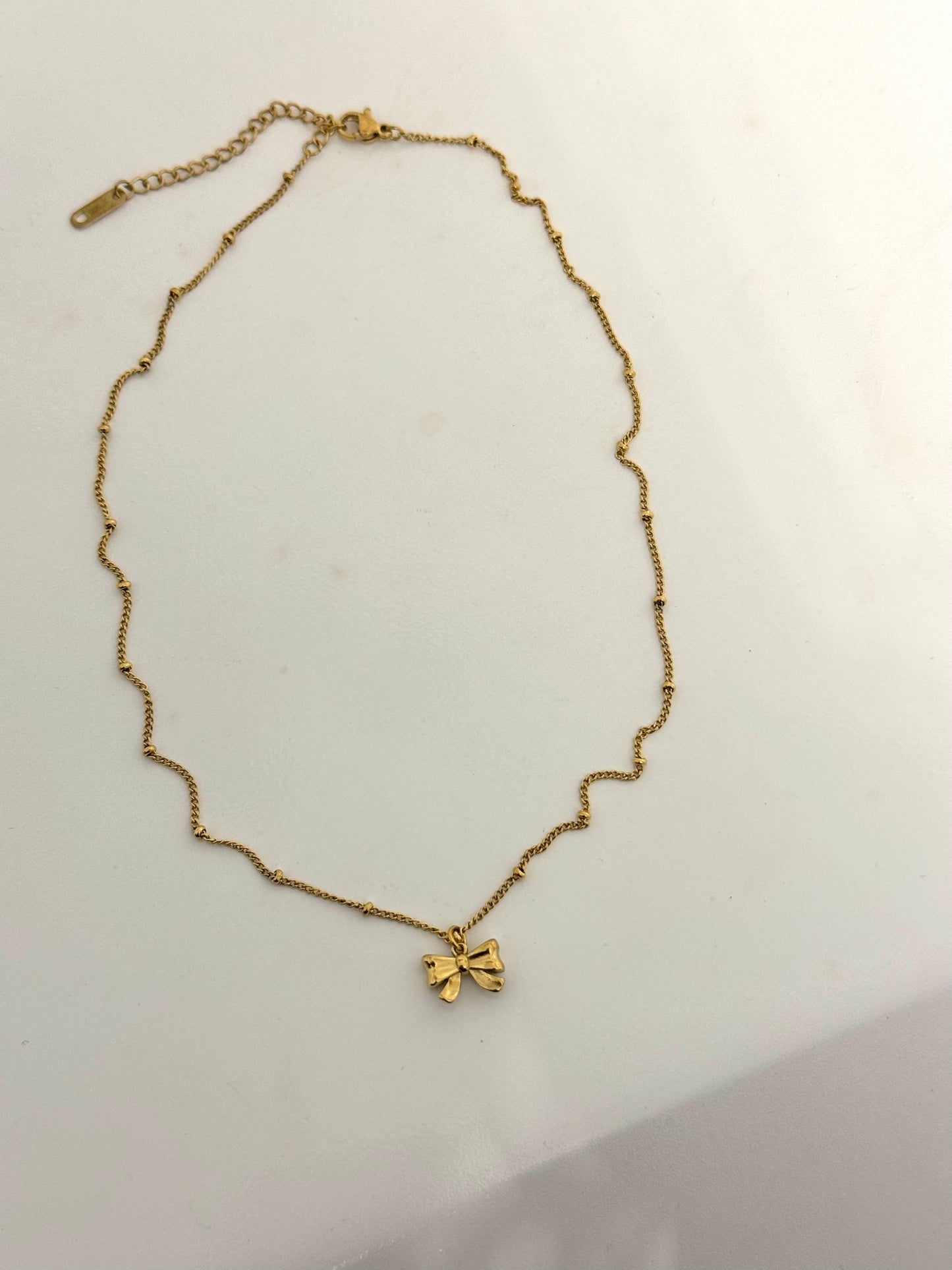 Minimalist gold bow necklace