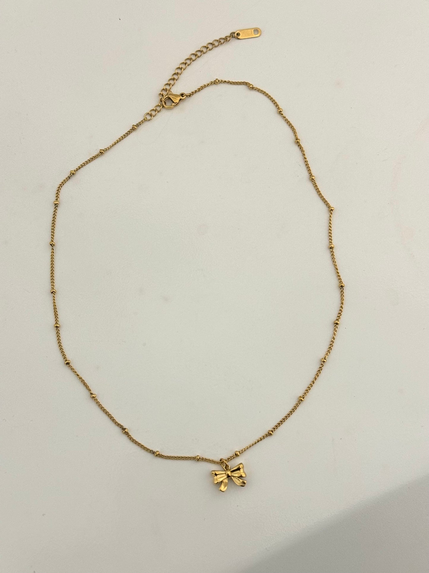 Minimalist gold bow necklace